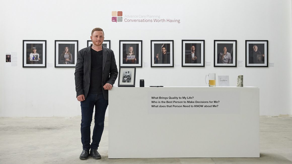 Photo of Brandon Marsh Photography standing in front of artwork